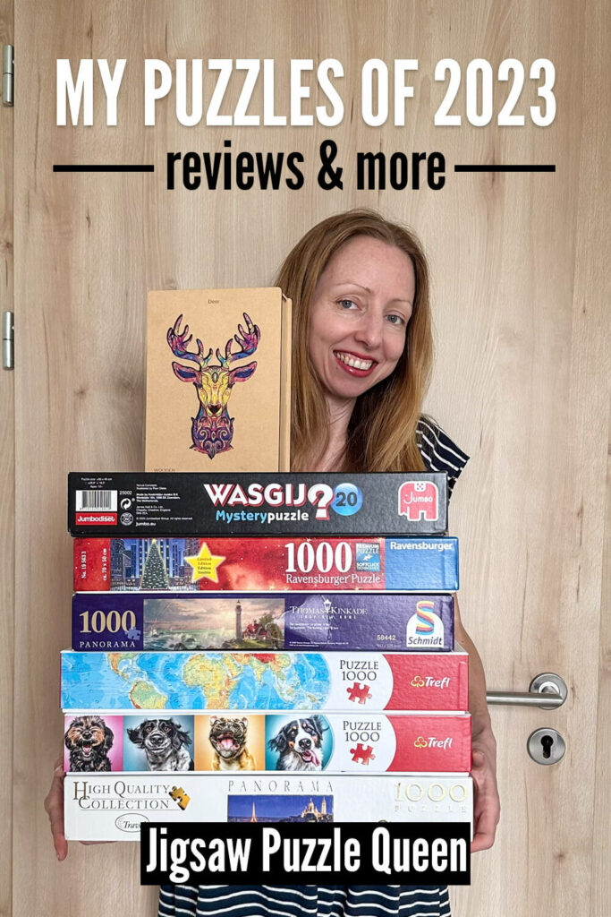 Holding a stack of jigsaw puzzles reviewed in the past year